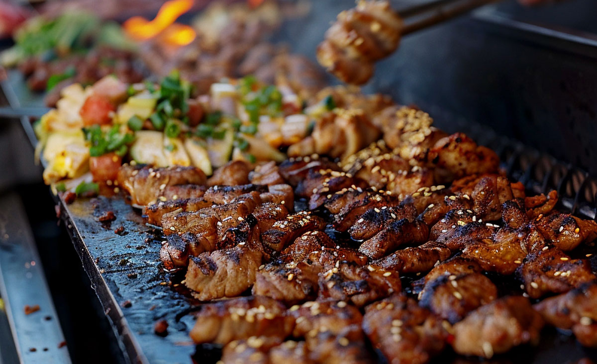 Selection of grilled meat skewers and vegetables on a flat top grill for Corporate BBQ Catering Ideas.