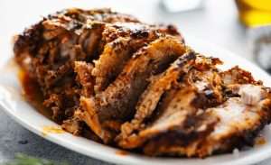What to Eat with Pulled Pork served with juicy sliced smoked pork on a plate