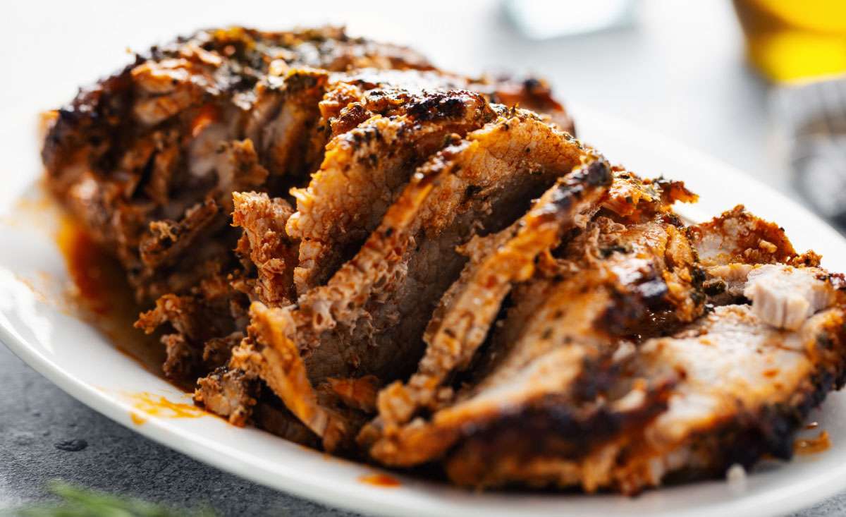 What to Eat with Pulled Pork served with juicy sliced smoked pork on a plate