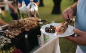 Corporate picnic BBQ catering Atlanta with grilled food served at an outdoor company event.